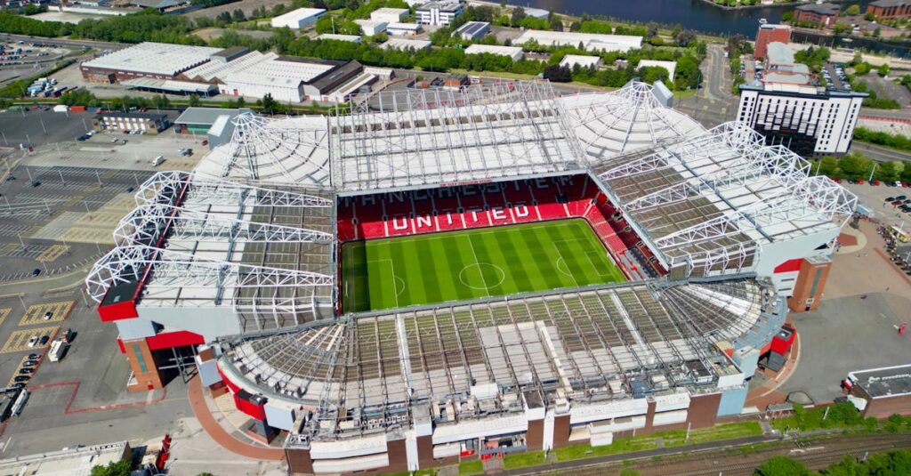 Stunning aerial shot of Old Trafford stadium in Manchester, showcasing its iconic architecture.