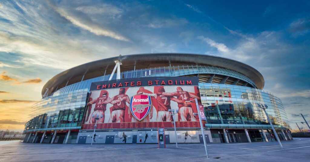 View of Emirates Stadium, home of Arsenal FC in London, showcasing modern architecture under a vibrant sky.